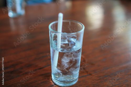 cold water inside glass placed on dining table is prepared for customers drink while eating or as drinking water while waiting for their orders. Concept of preparing drinking water ready for customers