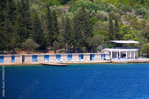 Beautiful beach with blue and white changing cabins, in Vela Luka, small town on island Korcula, Croatia.