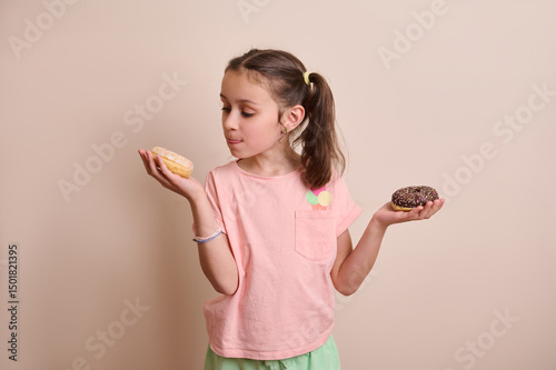 Smiling Young Girl Debates Between Two Delicious Doughnuts