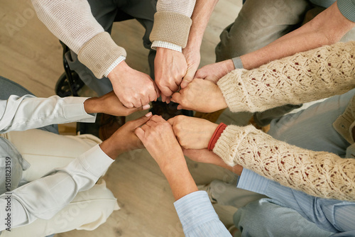 Billede på lærred Group of people joining hands in unity, creating a circle of support