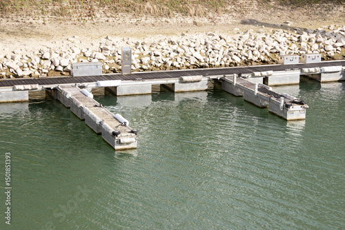 Modern pontoon for yachts and boats with adjustable water level and stabilization system, providing secure mooring and alignment with the shore in any conditions. photo