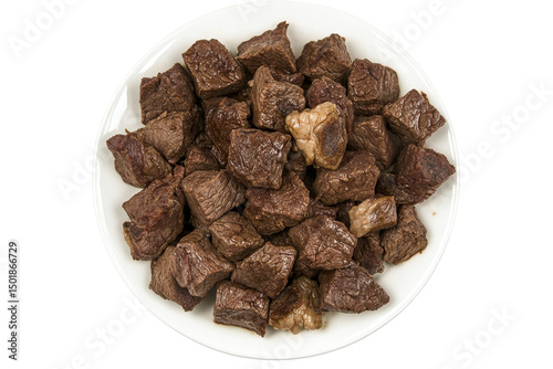 Diced beef cubes on a white plate presented against a white background