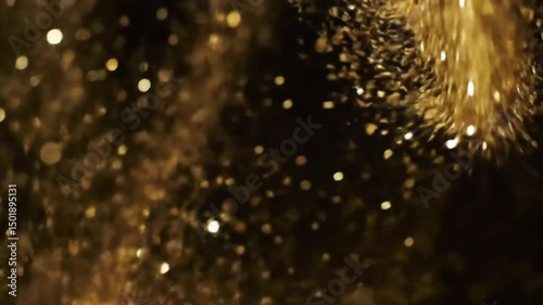 Sparkling golden glitter on a dark background, creating a magical, celebratory feel. The glitter particles appear to be floating.