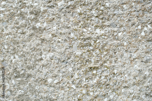 Rough cast concrete wall with stone aggregate A durable and textured surface showing weathering and age