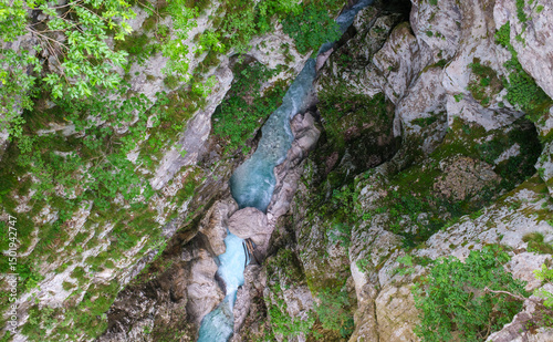 Aerial view of a stunning turquoise river flowing through a rugged moss covered canyon A scenic nature shot