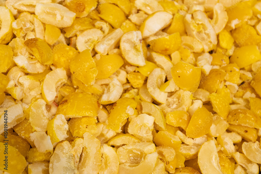 A close-up image showing chopped frozen quinces in various sizes, highlighting their yellow color and icy texture, ideal for culinary use. A close-up image showing chopped frozen quinces in various sizes, highlighting their yellow color and icy texture, ideal for culinary use.