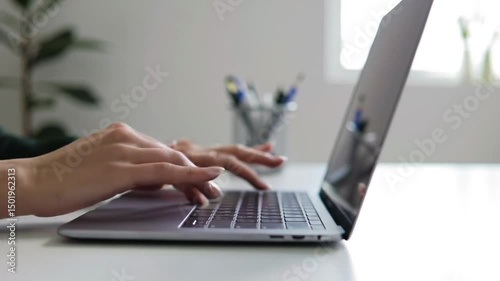 Typing on laptop keyboard for work study or business writing email document on computer at desk office