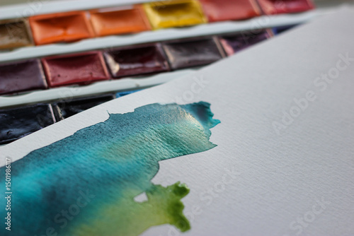 Watercolor stains and watercolor paints. Watercolor texture. Watercolor paints in cuvettes. Aquarelle painting concept. Paper texture