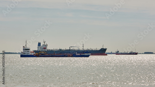 Dredger and cargo ships anchored on the Western Scheldt near Vlissingen