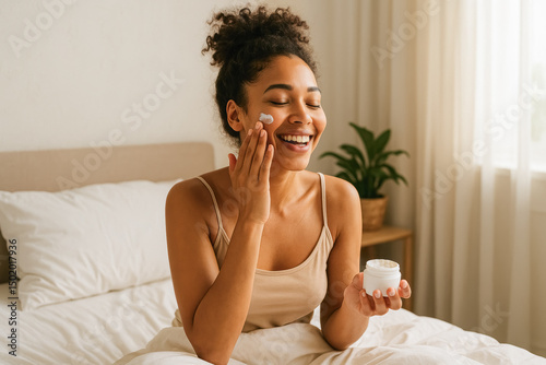 Smiling woman applying face cream in bed during a relaxed morning skincare routine. generative AI