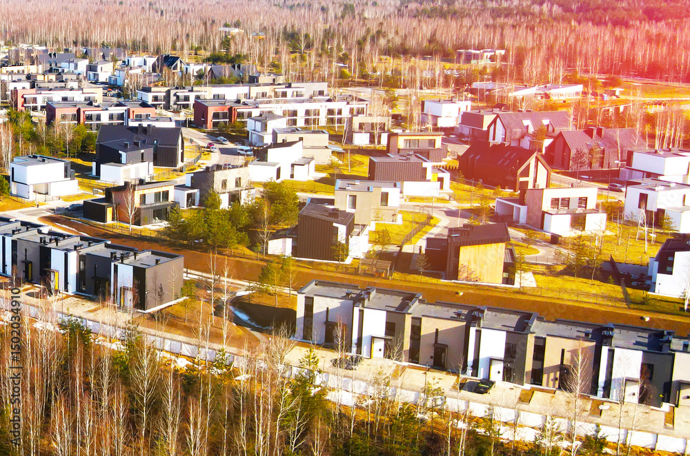 Fototapeta premium Installation of storm sewers and construction of a road in a new residential area. Excavator on earthworks, view from the top, view from the drone. Roadworks soil compactor