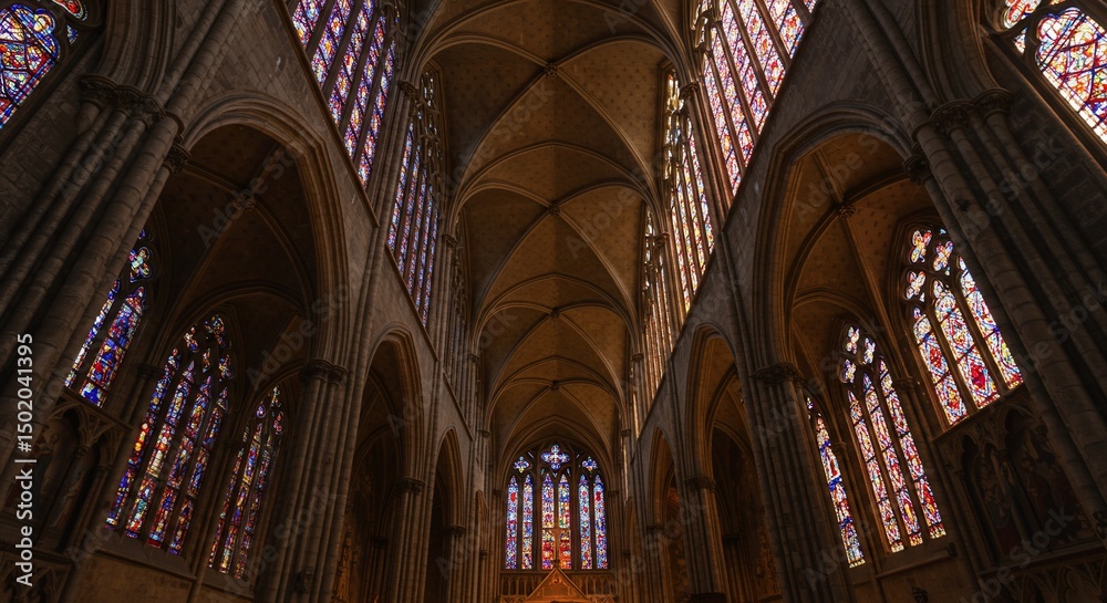 Obraz premium Gothic architecture of St Vitus Cathedral in Prague, showcasing the religious and historic interior with its ancient arches, stained glass windows, and soaring nave
