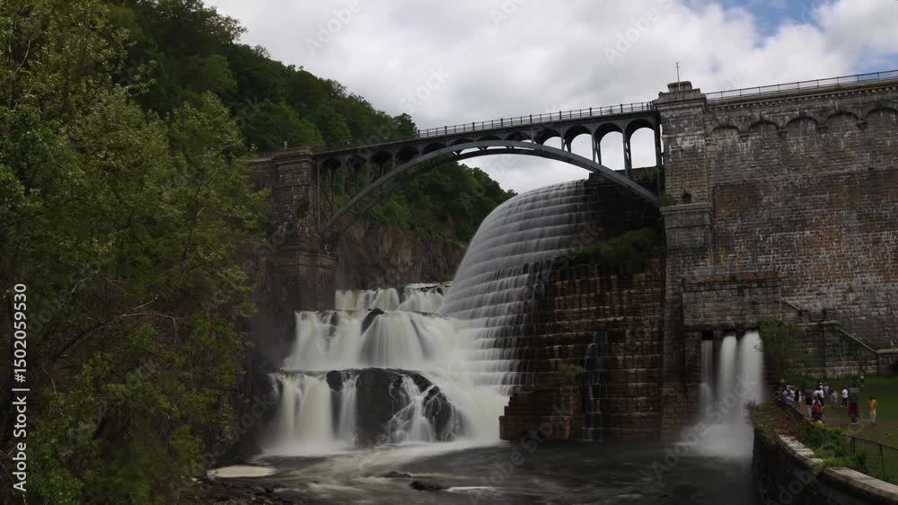 water cascading down waterfall at croton dam (man made and natural drinking water reservoir) westchester new york landmark with old bridge (tourism travel hiking destination) nature landscape