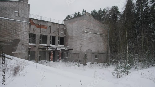 Wallpaper Mural An eerie and haunting view of a dilapidated, abandoned structure surrounded by towering, snowcovered trees Torontodigital.ca
