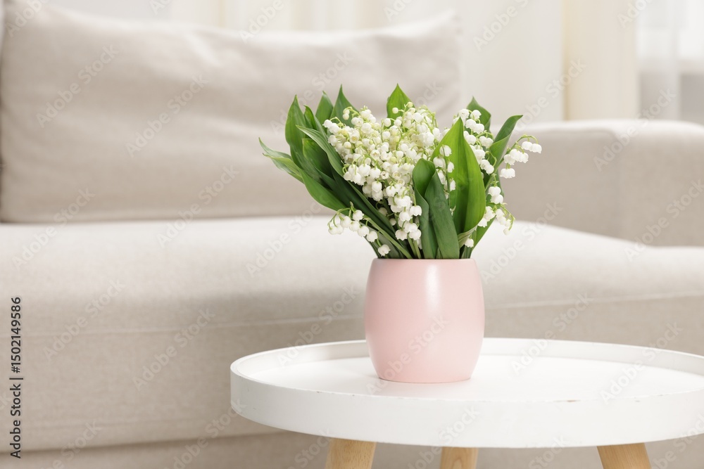 Fototapeta premium Bouquet of beautiful lily-of-the-valley on coffee table indoors. Space for text