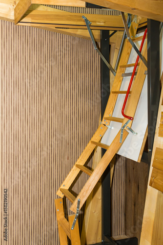 Retractable wood material attic ladder stairs inside house interior