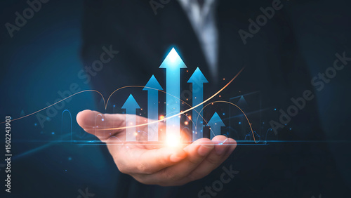 Hand holding glowing arrows pointing upward representing growth and success against a dark background