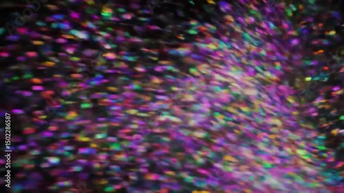 A visually captivating display of colorful particles illuminated against a dark backdrop, creating an abstract and dynamic composition.