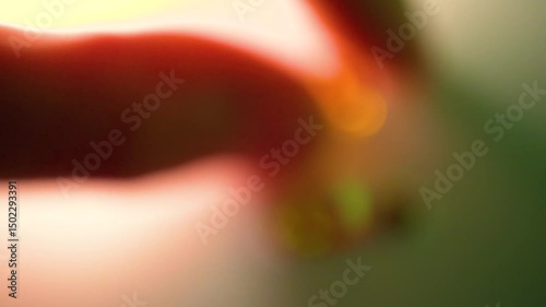 gemstones on a white table in multicolor illumination, A man's hand holds the jewels