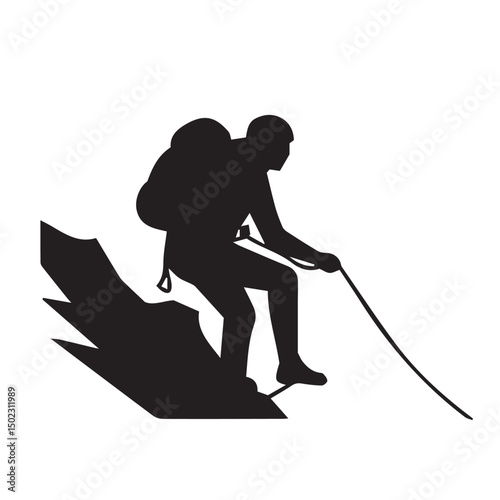 Silhouette of a climber descending a mountain using a rope and safety gear