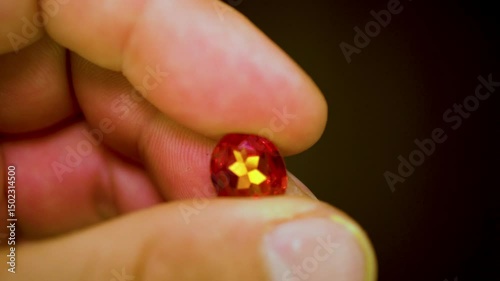 gemstones on a white table in multicolor illumination, A man's hand holds the jewels