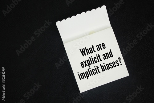 Paper book with the question words What are explicit and implicit biases?