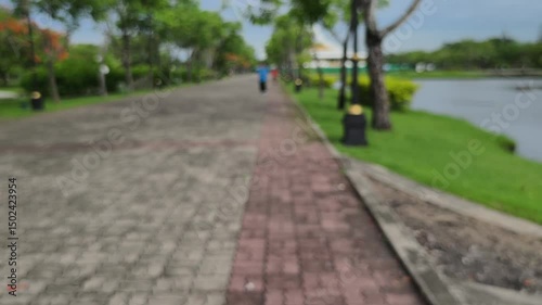 Wallpaper Mural 4K Slow Motion Video Footage. Blurred Background and Bokeh of Park in the Morning. Walking and Jogging Road for Exercise. People Walking for Exercise. Torontodigital.ca