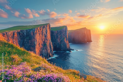 Dramatic sunset over rugged cliffs and coastline.