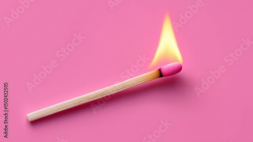 Burning matchstick on pink background