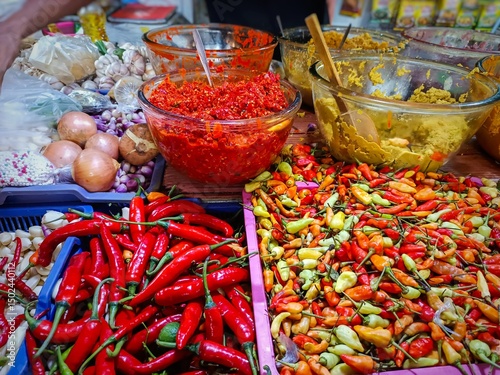 Colorful chili peppers and spices at a traditional market—ideal for culinary, food industry, or spicy cuisine themes. Vibrant and flavorful ingredients from Southeast Asia