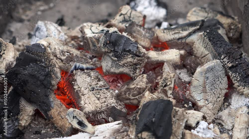 Glowing coals smoldering in a metal grill close-up after cooking kebabs during barbecue Glowing coals smoldering in a metal grill close-up after cooking kebabs during barbecue