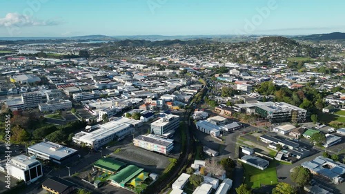 Drone view of Whangarei’s central area with roads, rooftops and distant greenery in New Zealand.