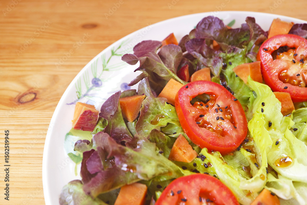 Mouthwatering Colorful Tomato and Lettuce Salad Garnished with Black Sesame Mouthwatering Colorful Tomato and Lettuce Salad Garnished with Black Sesame