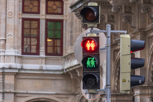 Close-up photo of couple pedestrian traffic light near Vienna State Opera in Austria, featuring same-sex couple icons – a symbol of diversity, inclusion, and LGBTQ+ rights