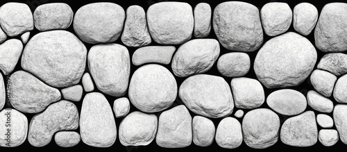 A close-up of a wall made of various sized, smooth, white stones
