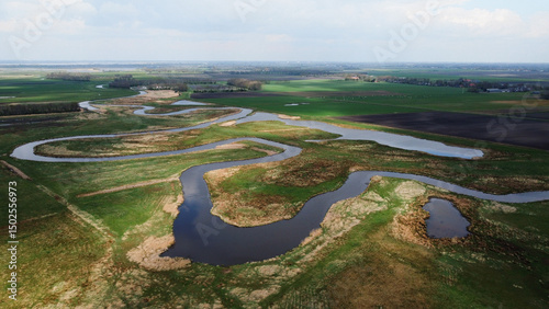 Fotografia Meandering river nature landscape aerial drone photo grass land and body of water stream curves and corners