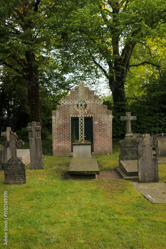 Graveyard tombstone cemetery Christian cross religion faith garden park. Church building shed.