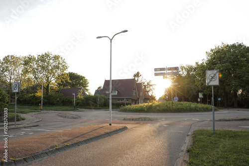 Road empty evening light, summer trees and grass in town local neighborhood peaceful rural landscape in Europe.
