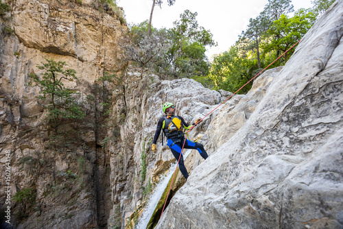 Man Rappelling During Canyoneering Adventure in Rocky Canyon