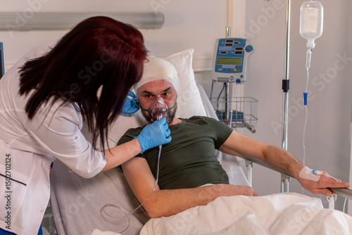 A patient is currently receiving medical care inside their hospital room for treatment needs