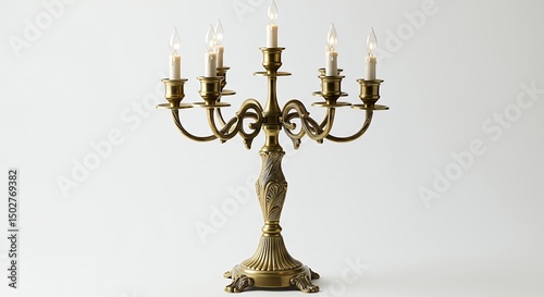 Ornate brass candleholder against white background