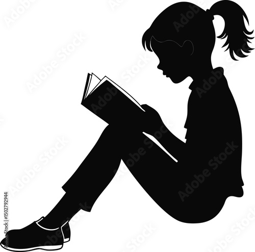 Silhouette of a young girl reading a book while sitting on the ground leisurely