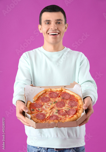 Young man with tasty pepper...