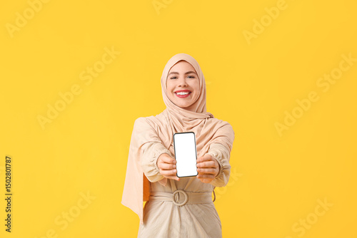 Muslim woman with mobile ph...