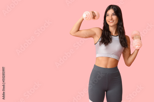 Young woman with dumbbells ...