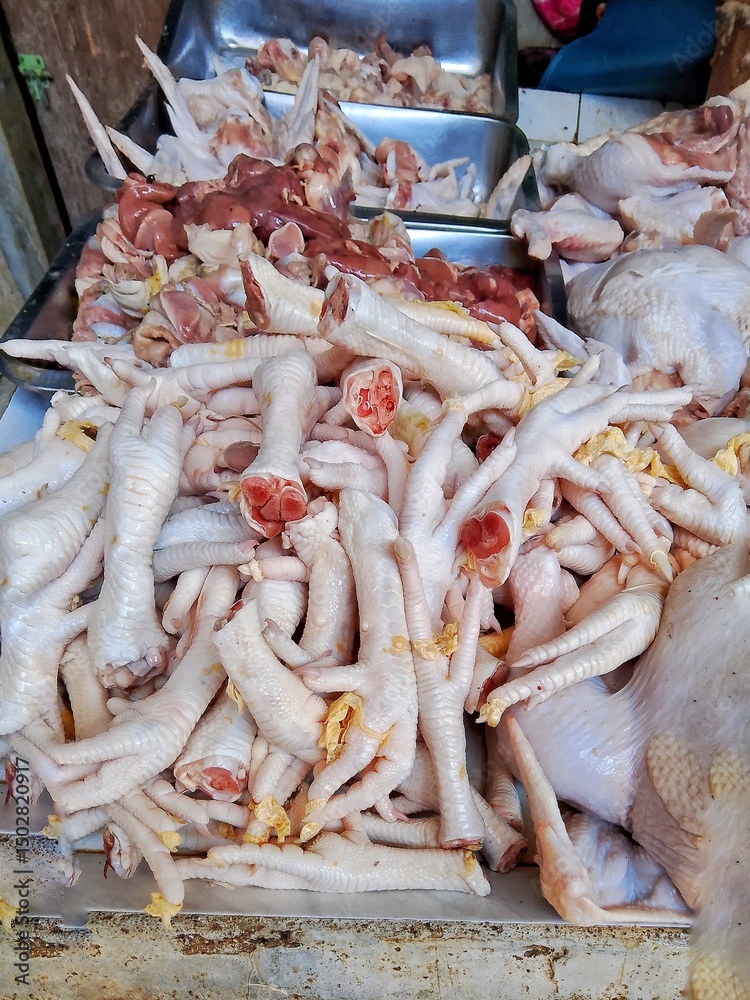 raw chicken feet and chicken meat displayed for sale at Traditional Market Stall raw chicken feet and chicken meat displayed for sale at Traditional Market Stall