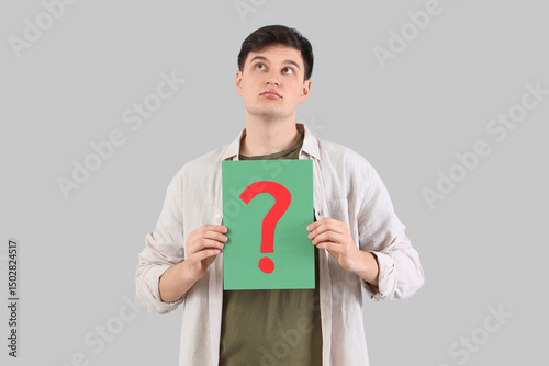 Young man with paper questi...