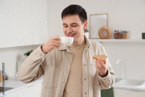 Young man holding toast wit...