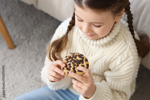 Little girl with cookie at ...