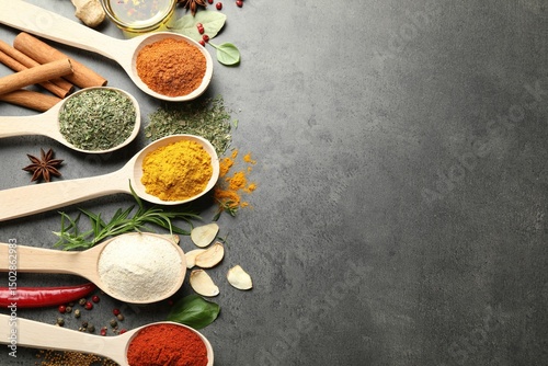 Fototapeta Naklejka Na Ścianę i Meble -  Many different spices in spoons on grey table, flat lay. Space for text
